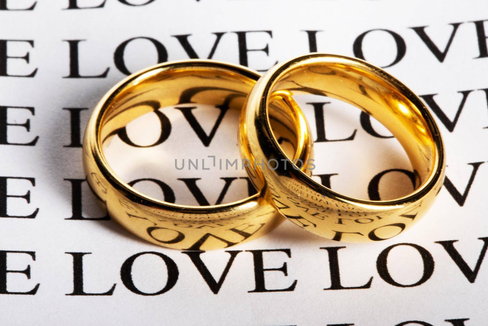 Two wedding rings made in gold and the word love