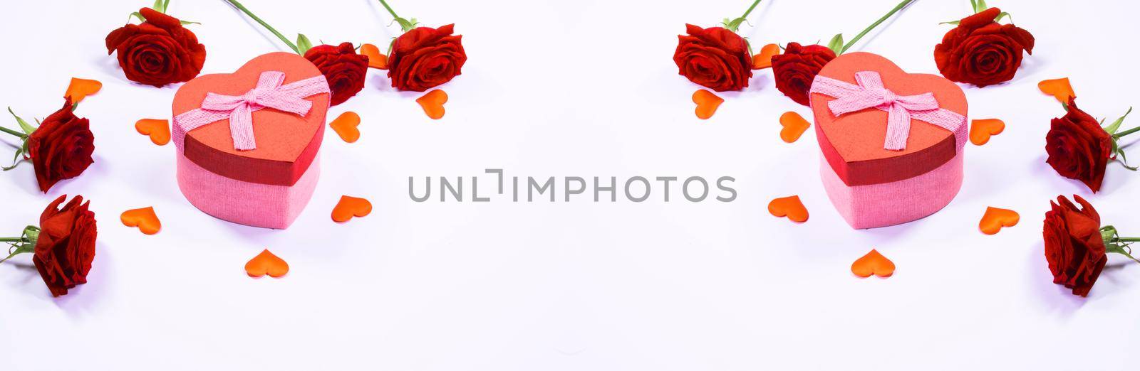 Valentines day frame of hearts, red rose flowers and gift box isolated on white background
