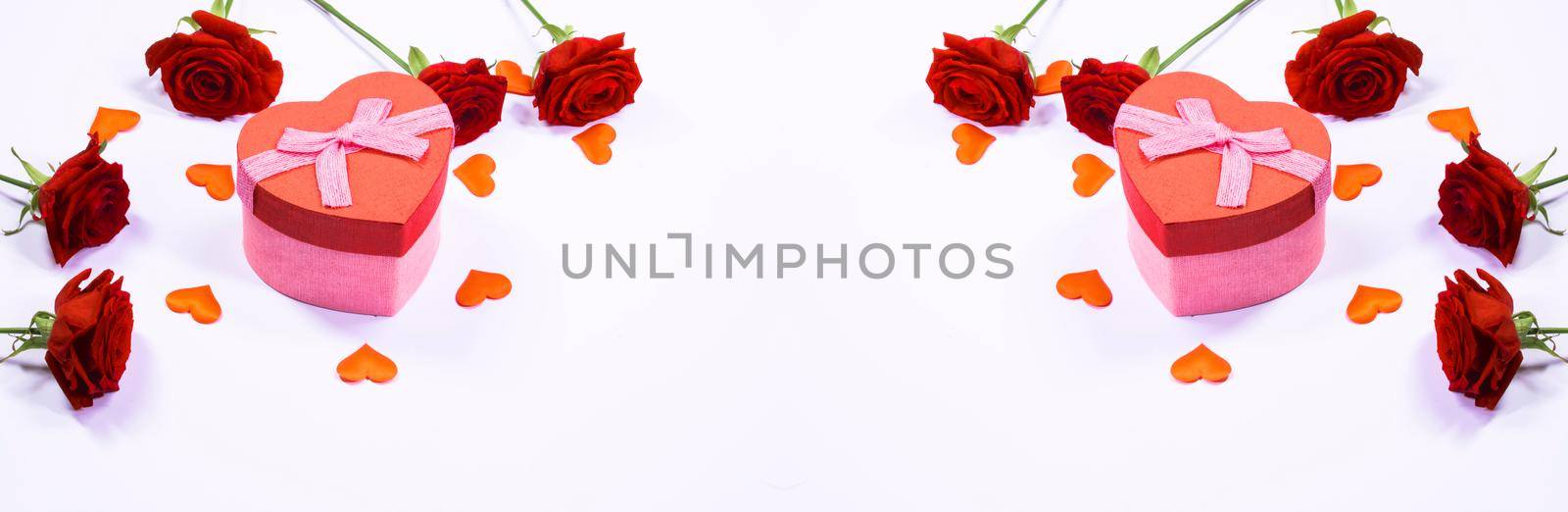 Valentines day frame of hearts, red rose flowers and gift box isolated on white background