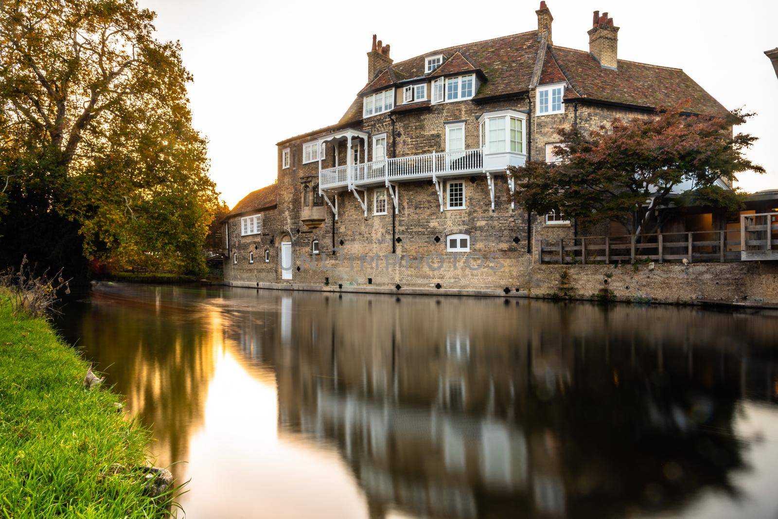 Long exposure of typical Cambridge building by the river in late afternoon light