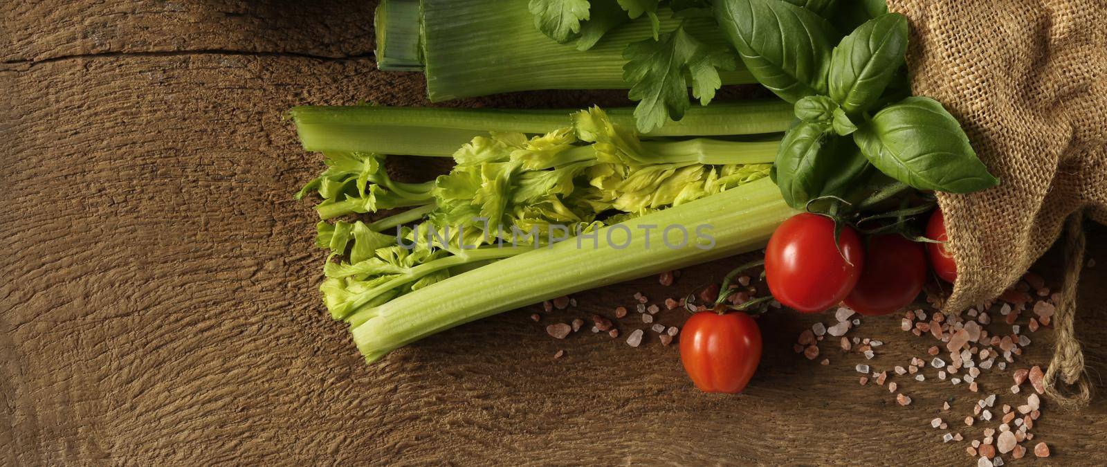 Rustic background with freshly picked vegetables, canvas bag on old wood background. Fresh Tomatoes, basil. Horizontal rustic background