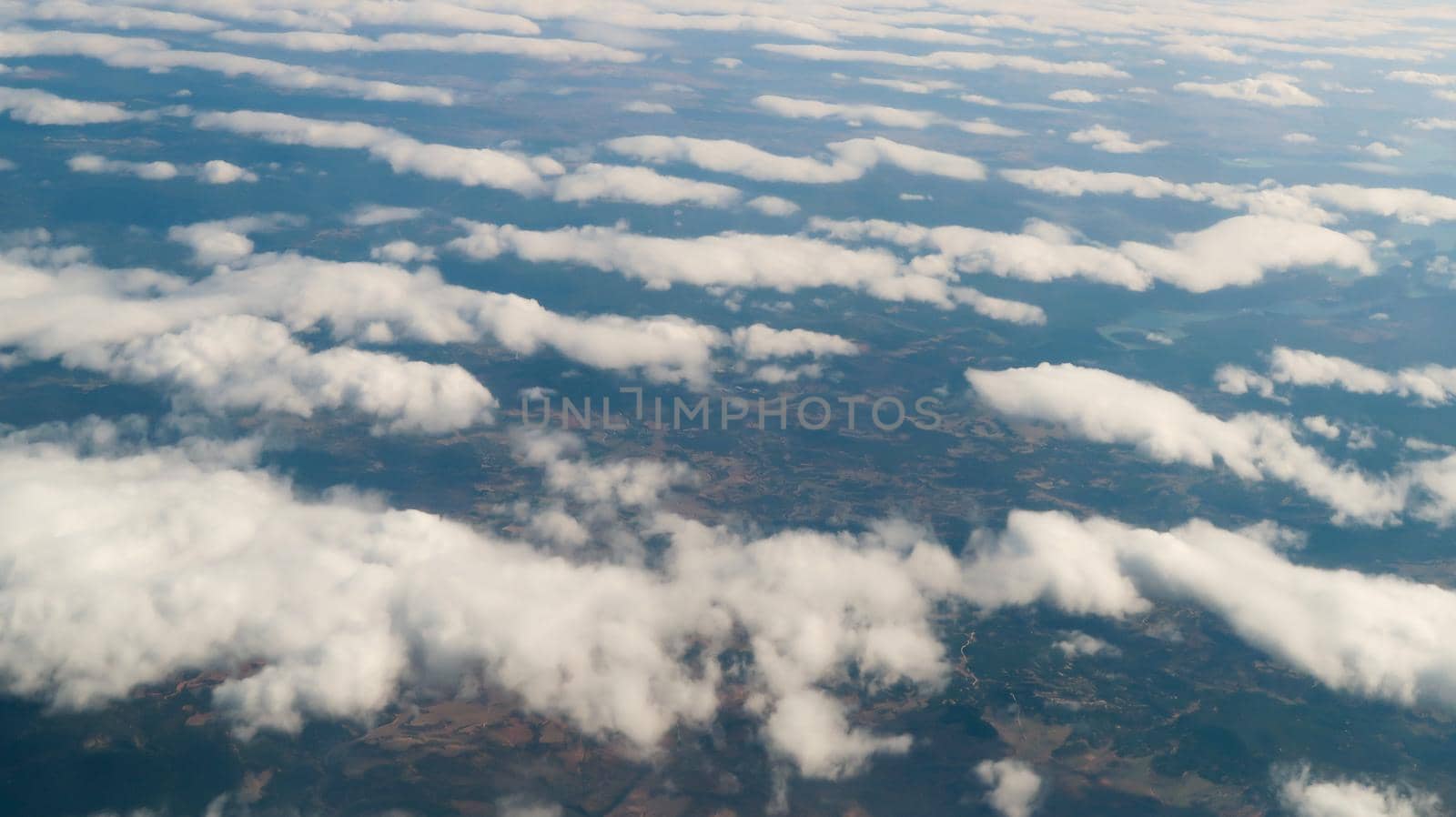 Cloudscape from airplane window. Clouds from above  by codrinn