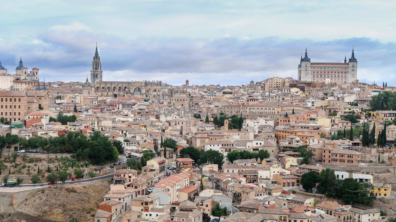 Mesmerizing shot of a beautiful cityscape and ancient Castle and Cathedral of Toledo in Spain by codrinn