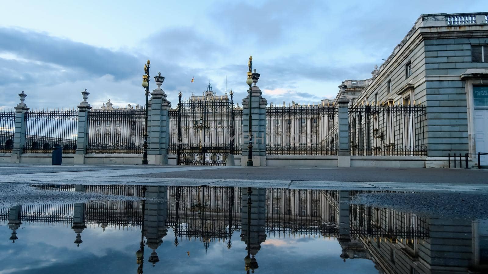 Royal Palace in Madrid reflecting in water after a rainy day, Spain by codrinn