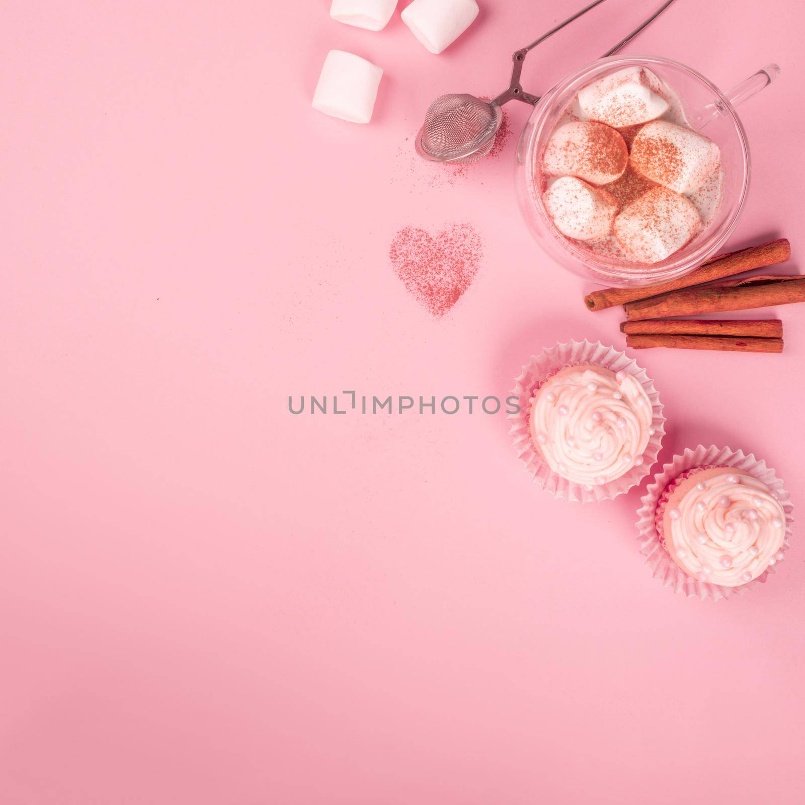 Valentine day love cupcake decorated with cream and hot chocolate on pink background with copy space for text