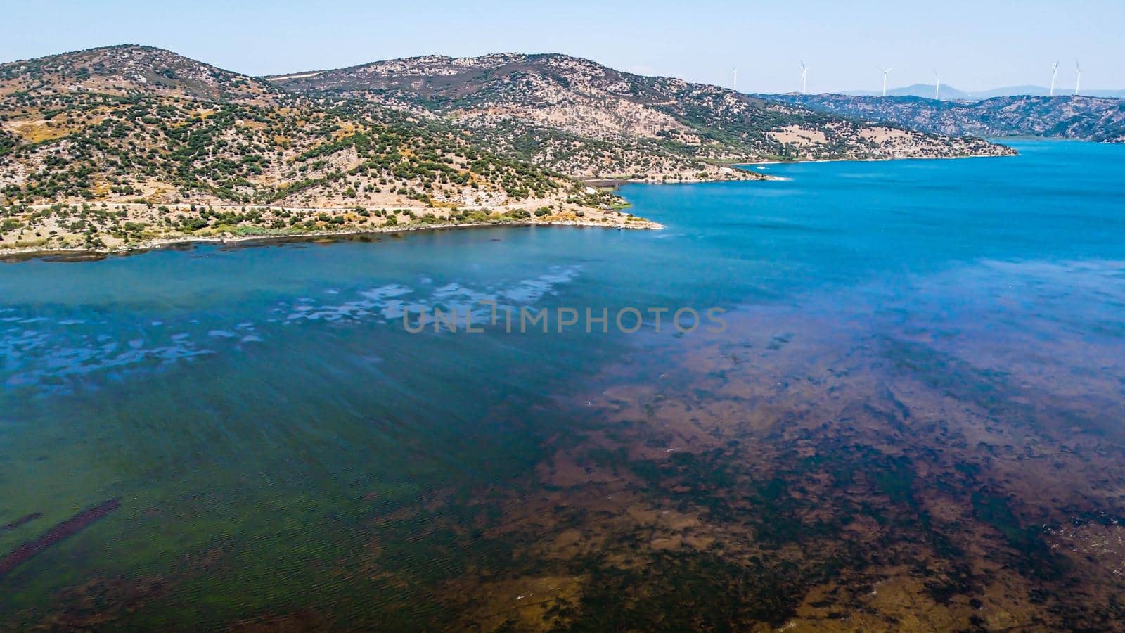 aerial drone shoot from side of an bafa lake at turkey. good looking blue dominant landscape and there is hills at background