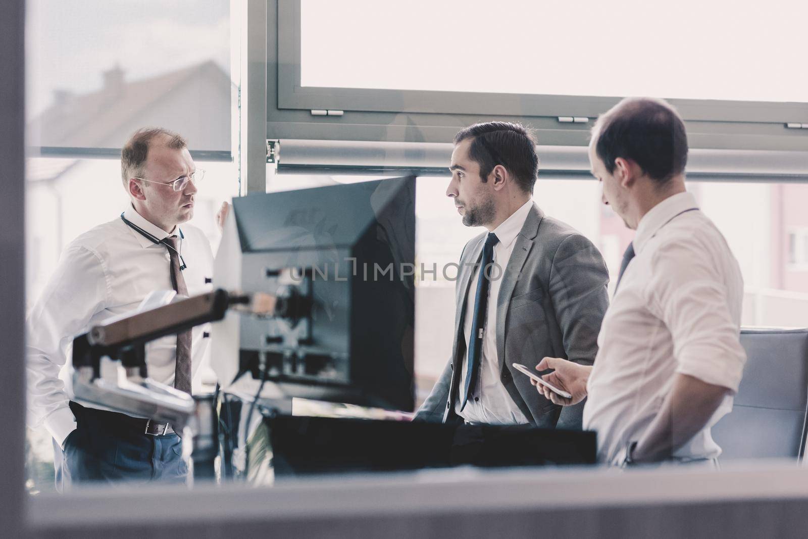 Corporate business people work in modern office. Project manager team solving a problem. Business crew discussing a business issue. Businessman looking at data at mobile phone monitor.