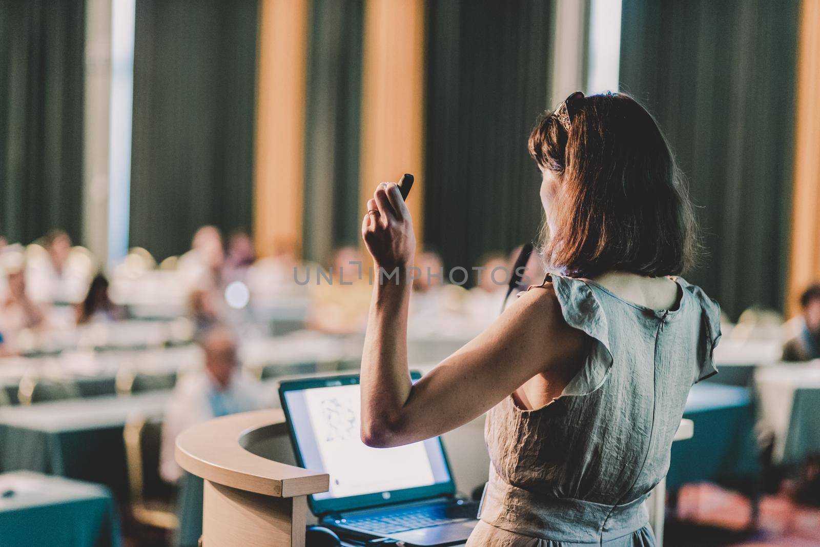 Female speaker at Business Conference and Presentation. Audience at the conference hall. Business and Entrepreneurship. Business woman. Horizontal composition.