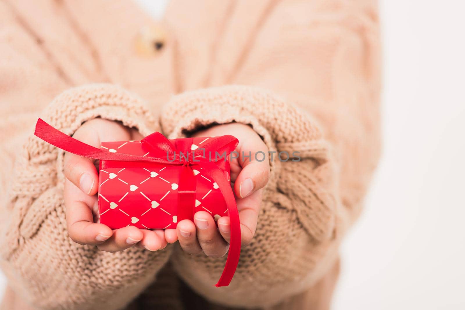 Valentine's Day. Woman beauty hands holding small gift package box present wrapped paper with ribbon isolated on white background, Birthday, New year, Christmas, holiday background concept