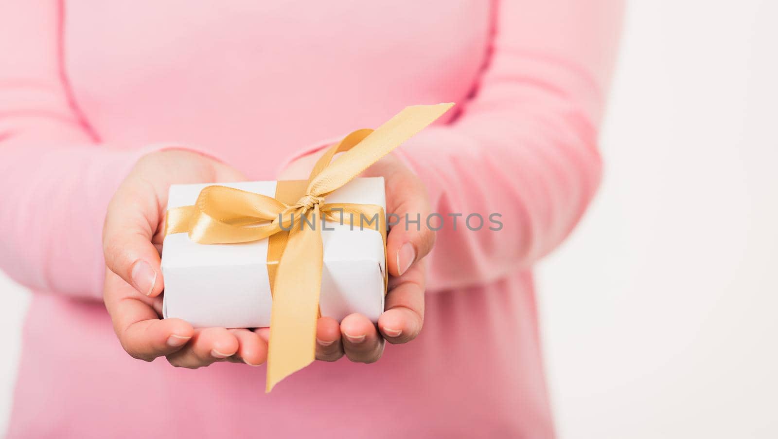 Valentine Day. Woman beauty hands holding small gift package box present wrapped paper with ribbon, Christmas, New year, Birthday holiday background concept