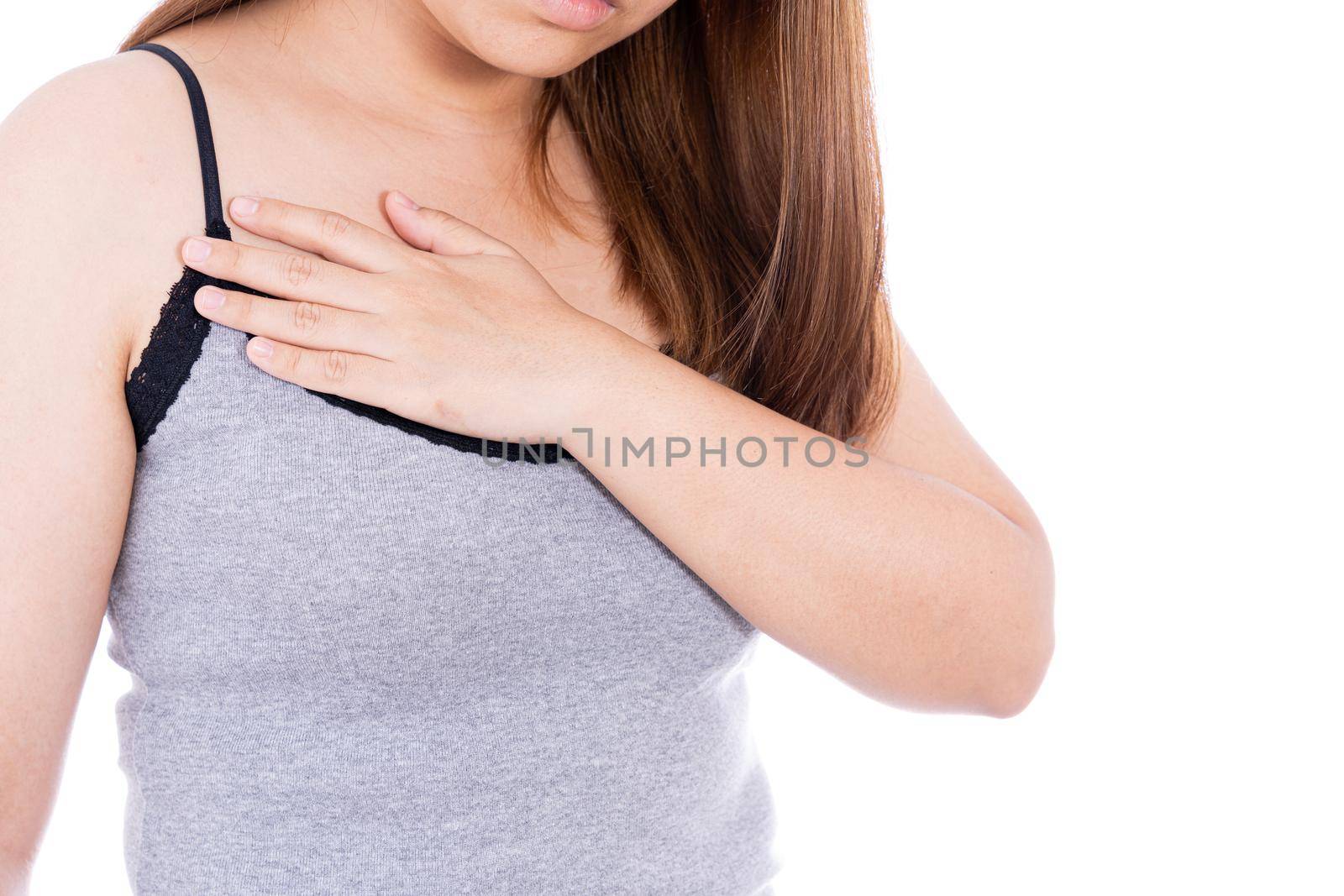 Woman touching her heart or chest isolated white background. Healthcare medical or daily life concept. by mikesaran