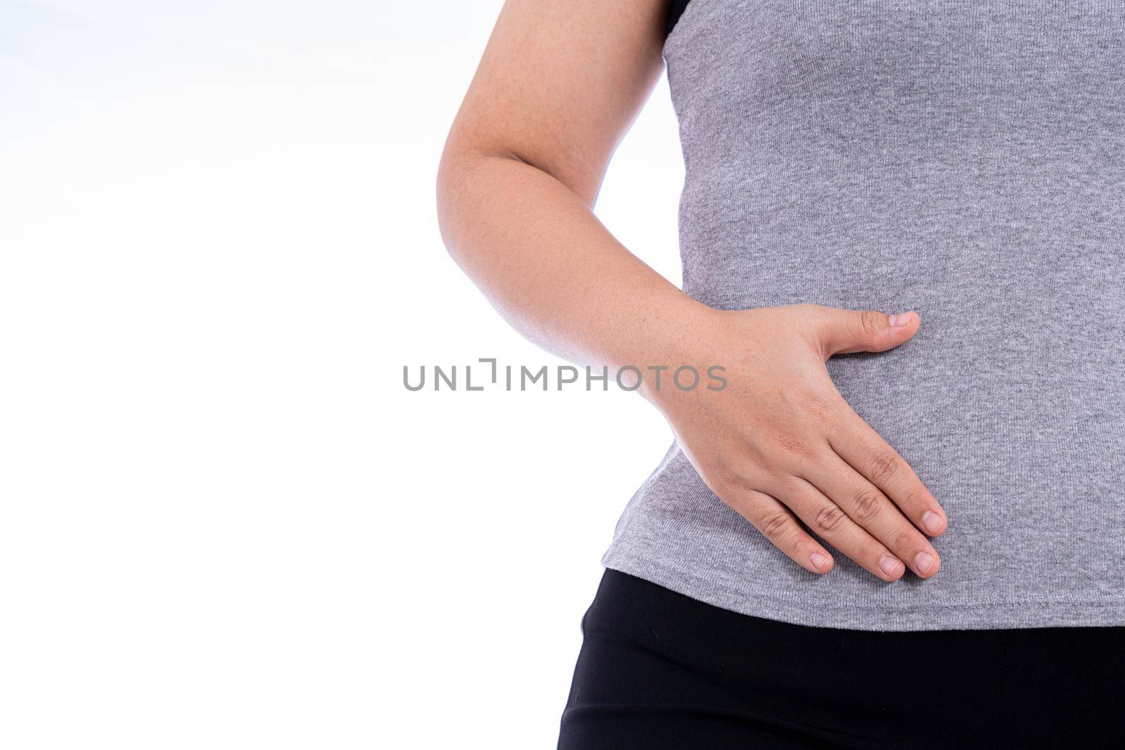 Woman hand touching stomach, waist, or liver position isolated white background. Health care and medical concept. by mikesaran