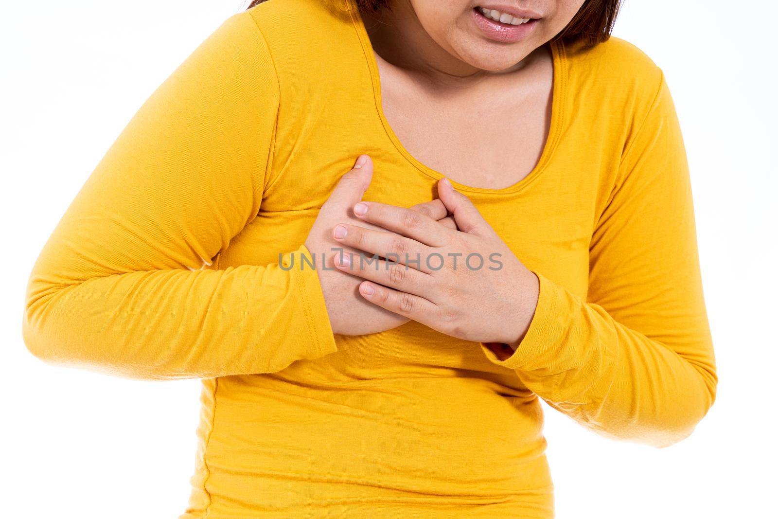 Woman touching her heart or chest isolated white background. Healthcare medical or daily life concept. by mikesaran