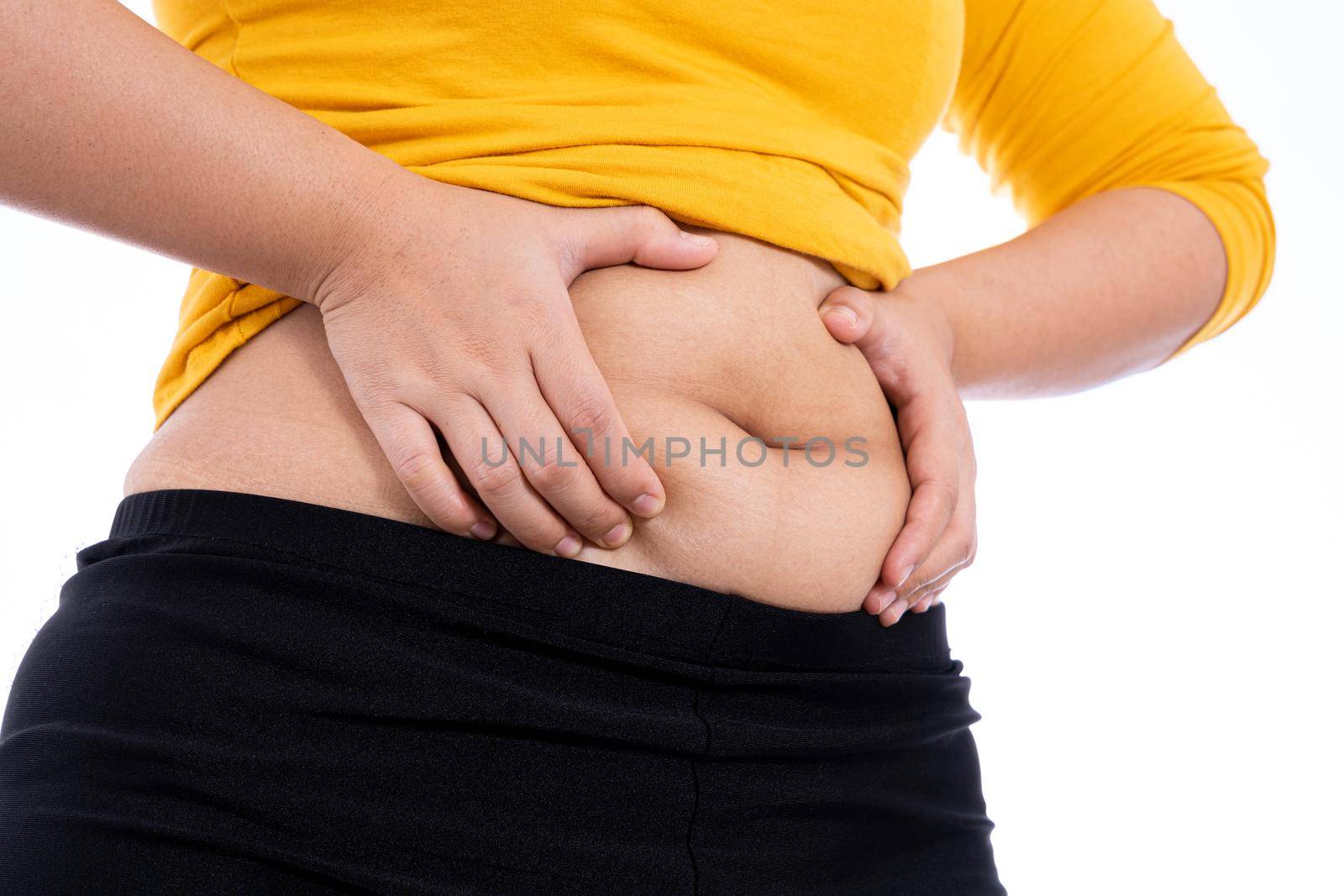 Fat woman holding excessive fat belly, overweight fatty belly isolated on over white background. Diet lifestyle, weight loss, stomach muscle, healthy concept.