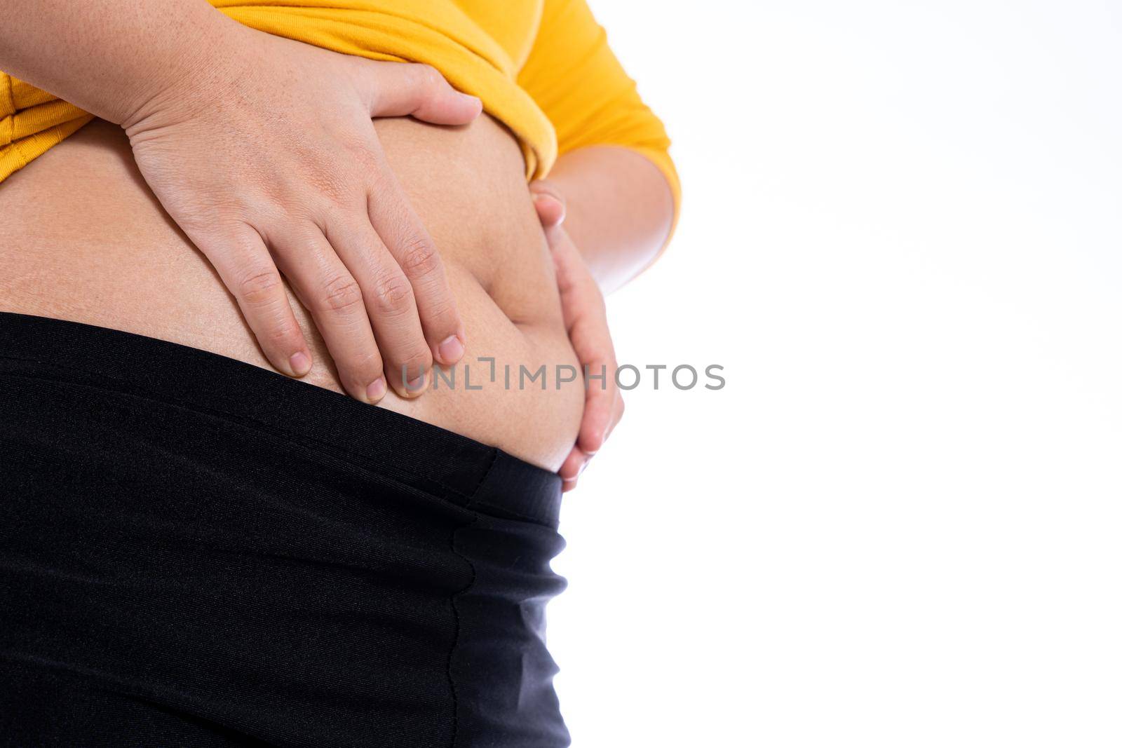Fat woman holding excessive fat belly, overweight fatty belly isolated white background. Diet lifestyle, weight loss, stomach muscle, healthy concept. by mikesaran
