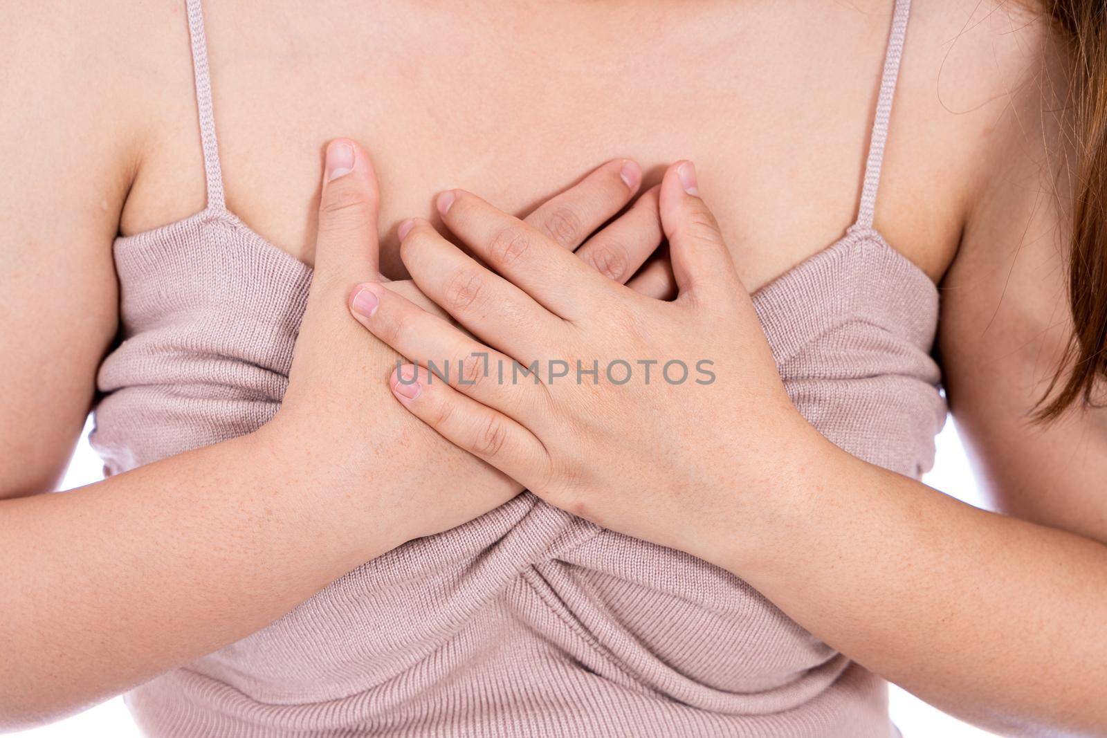 Woman touching her heart or chest isolated white background. Healthcare medical or daily life concept. by mikesaran