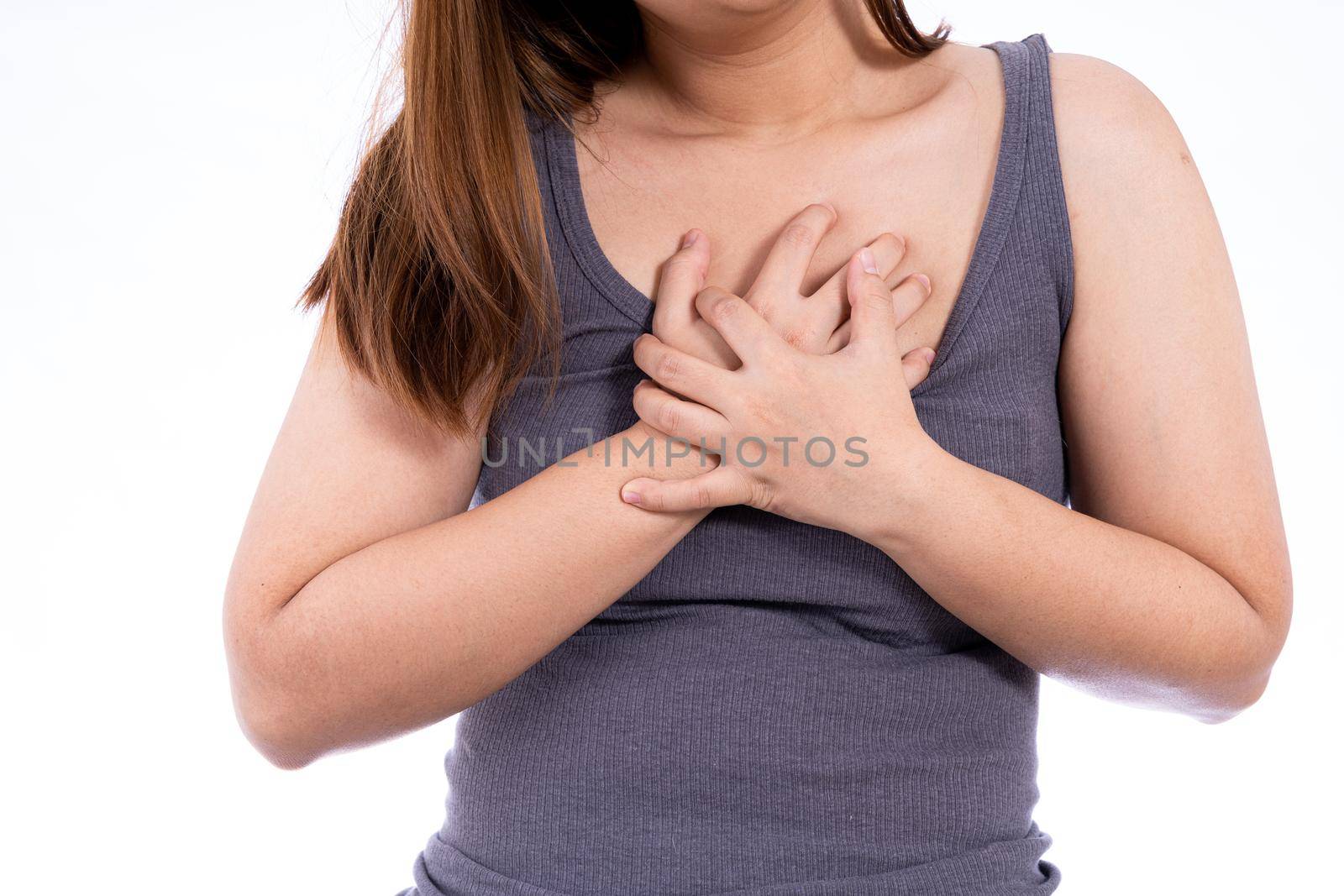 Woman touching her heart or chest isolated white background. Healthcare medical or daily life concept. by mikesaran