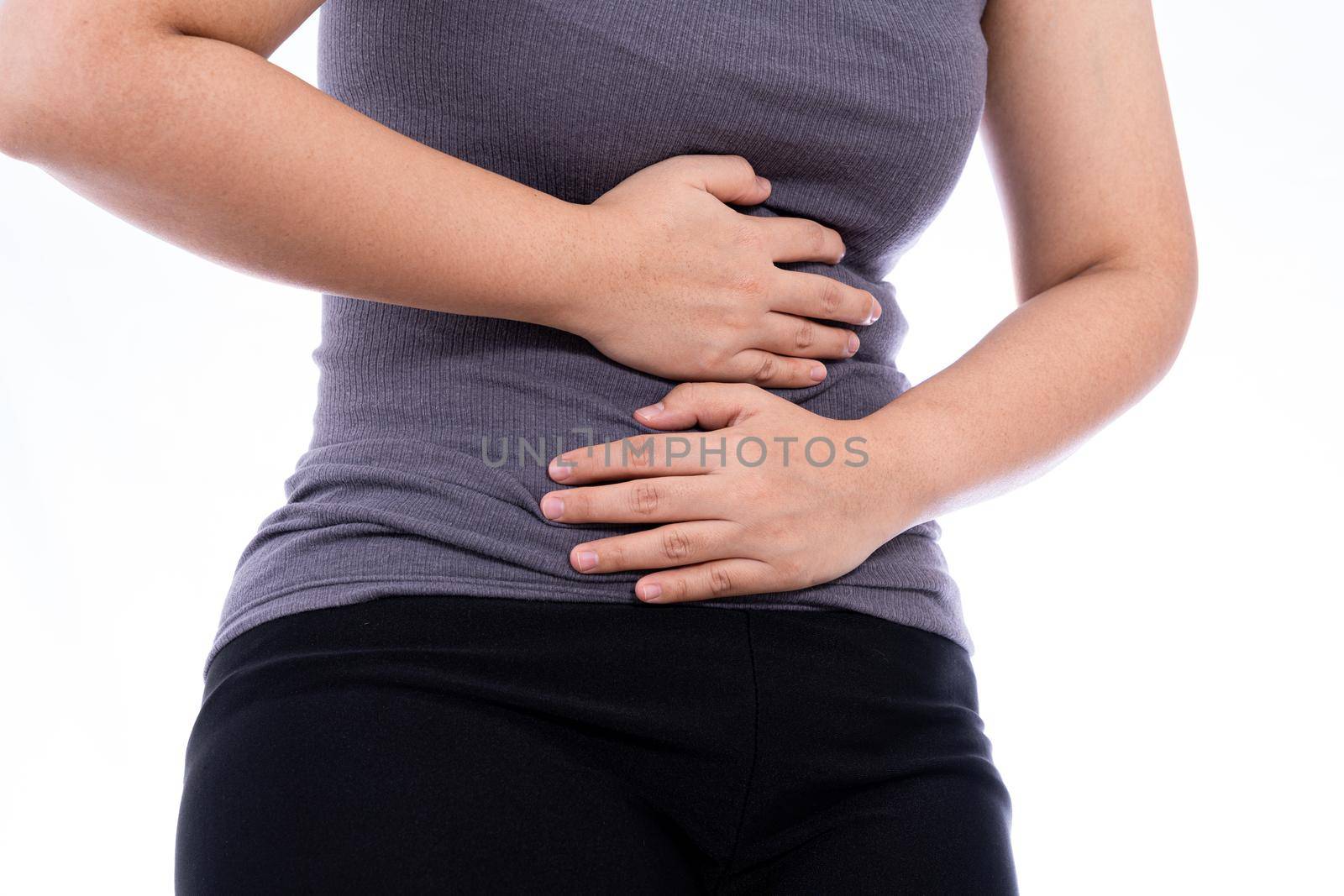 Woman suffering from stomach pain and injury isolated white background. Health care and medical concept. by mikesaran