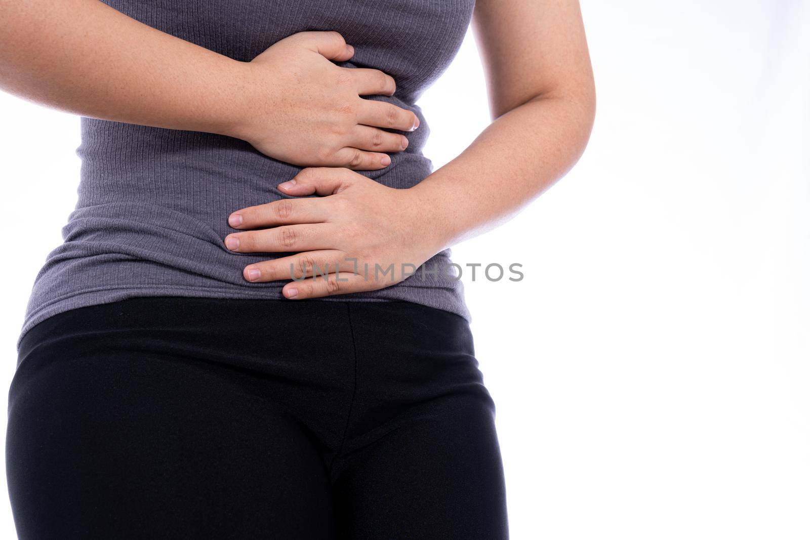 Woman suffering from stomach pain and injury isolated white background. Health care and medical concept. by mikesaran