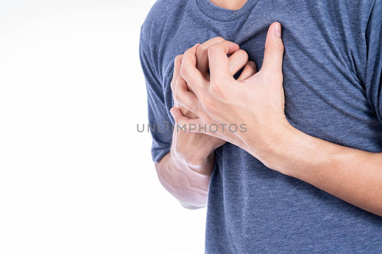 Man touching his heart or chest isolated white background. Healthcare medical or daily life concept. by mikesaran