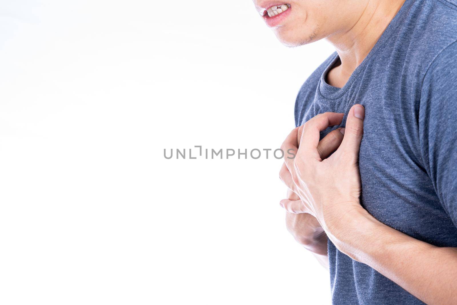 Man touching his heart or chest isolated white background. Healthcare medical or daily life concept.