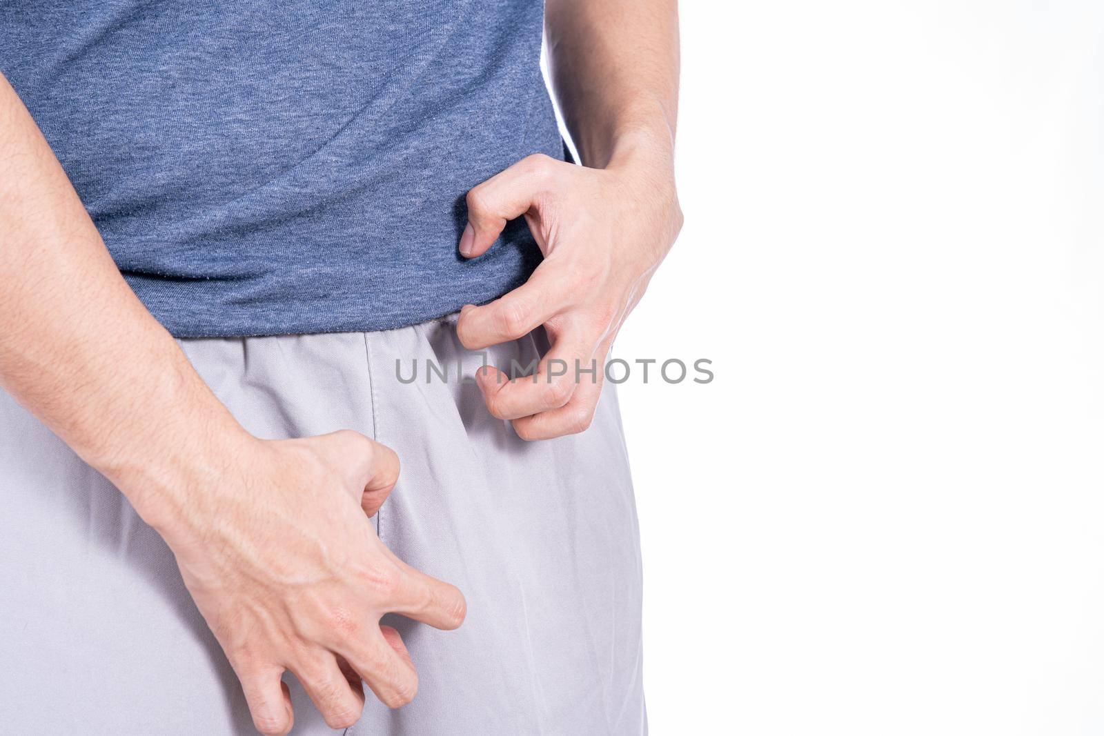 Man hands scratching his crotch isolated white background. Medical, healthcare for advertising concept.