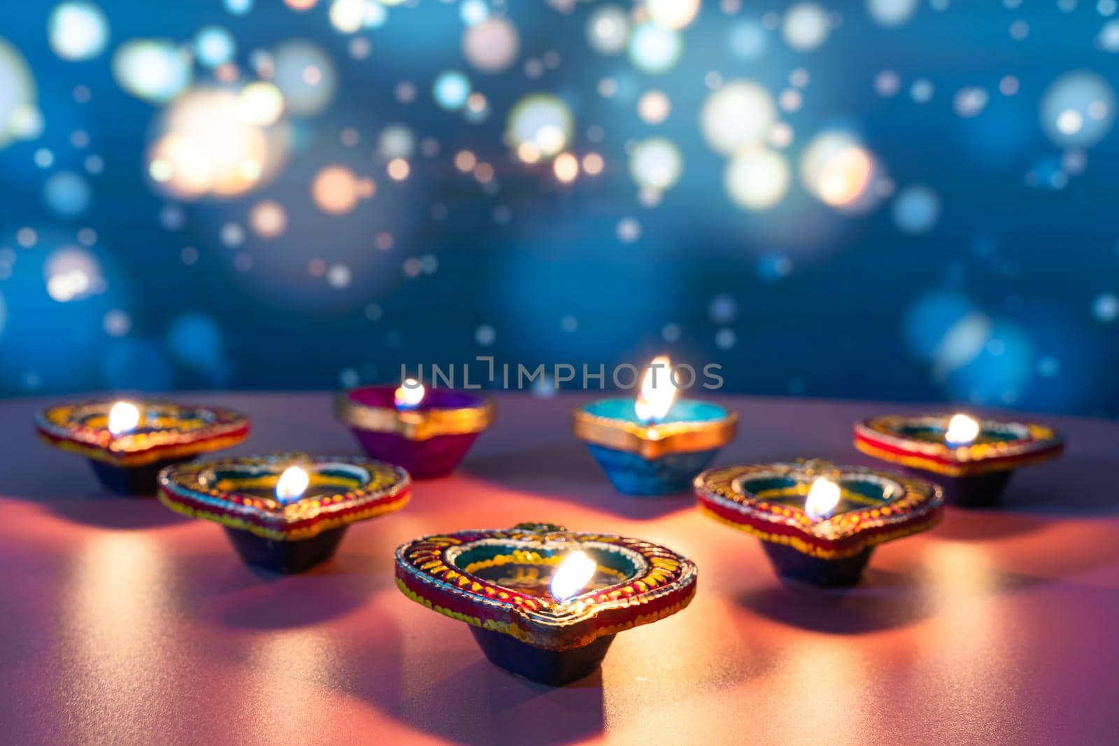 Indian festival Diwali, Diya oil lamps lit on colorful rangoli. Hindu traditional. Happy Deepavali. Copy space for text.