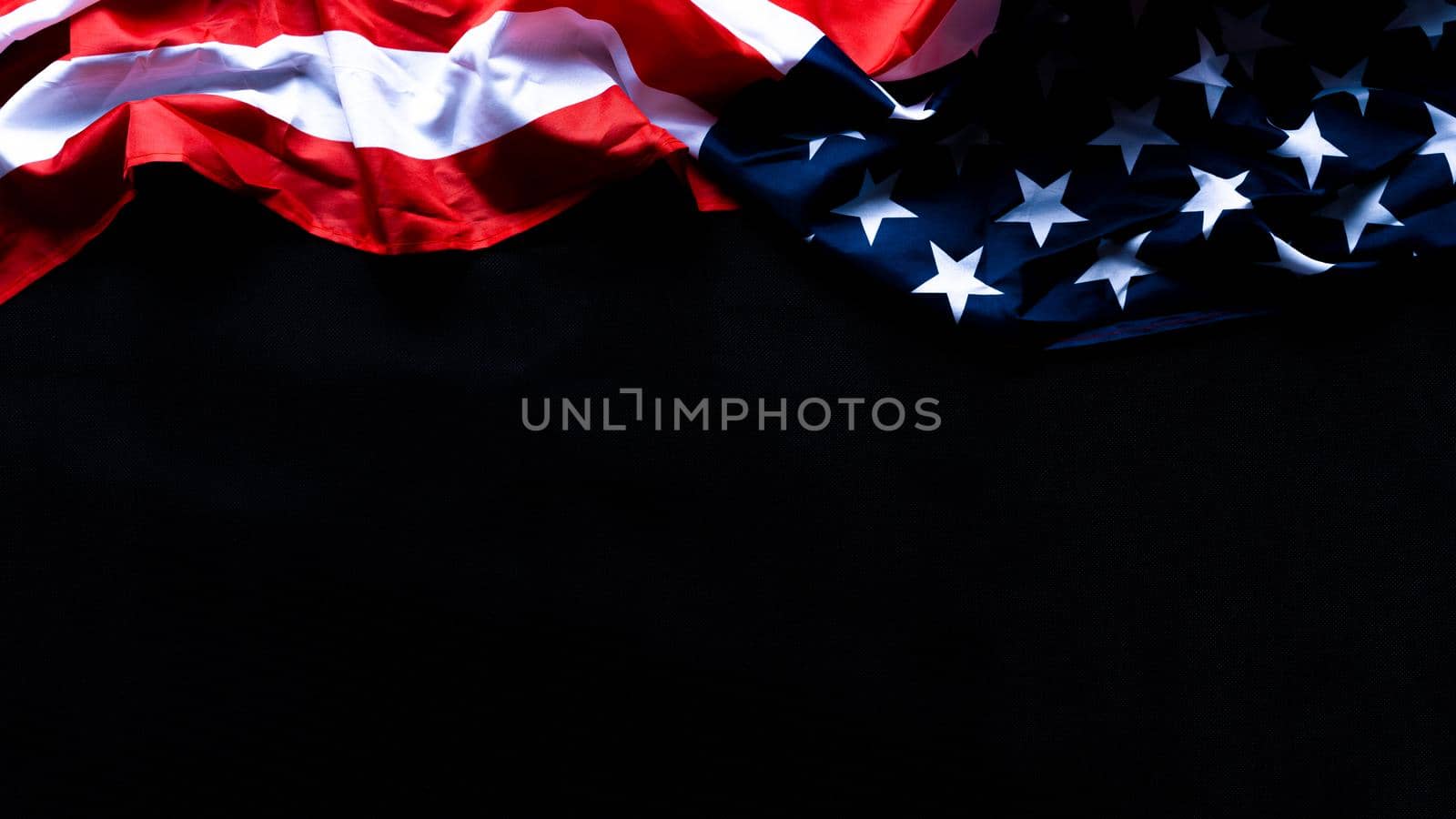 US American flag against black background. For Memorial, Presidents, Veterans, Labor, Independence or 4th of July celebration day. Top view, copy space for text. by mikesaran