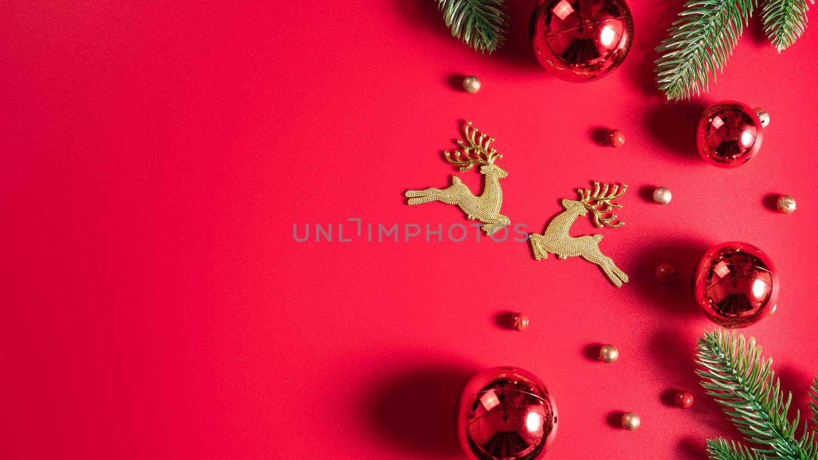 Christmas background. Top view of Christmas decorations on red background with copy space for text. Flat lay, winter, postcard template, new year concept.