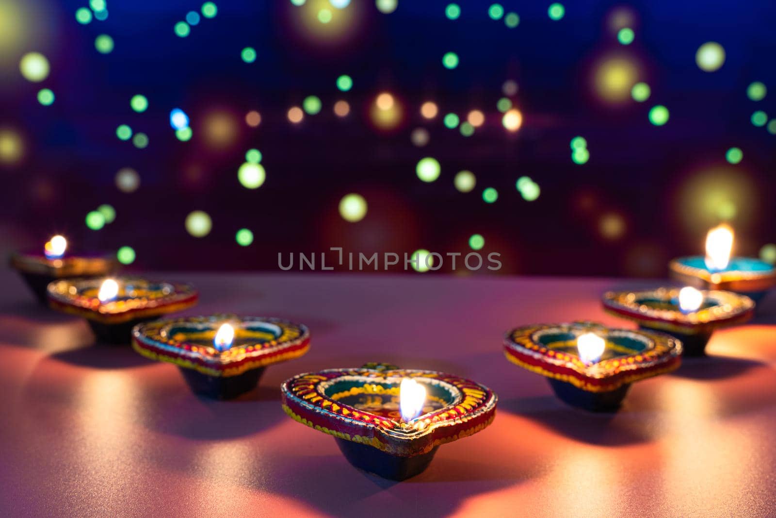 Indian festival Diwali, Diya oil lamps lit on colorful rangoli. Hindu traditional. Happy Deepavali. Copy space for text. by mikesaran