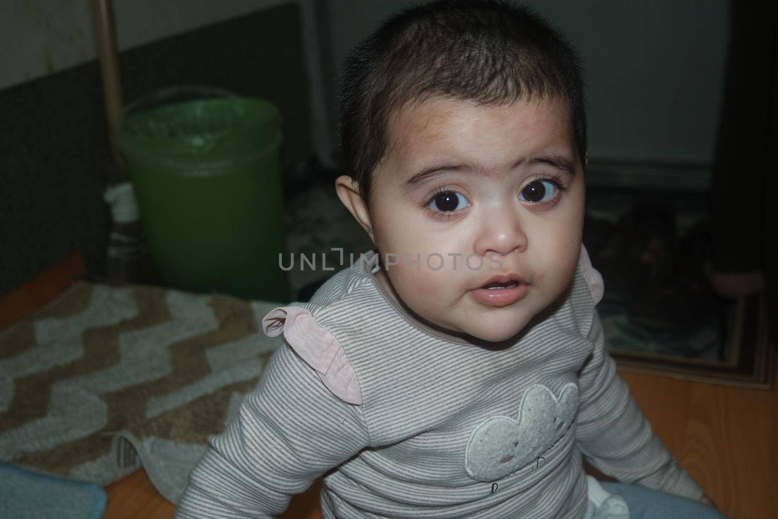 Baby girl with lovely face, big eyes and cute face gesture by Photochowk