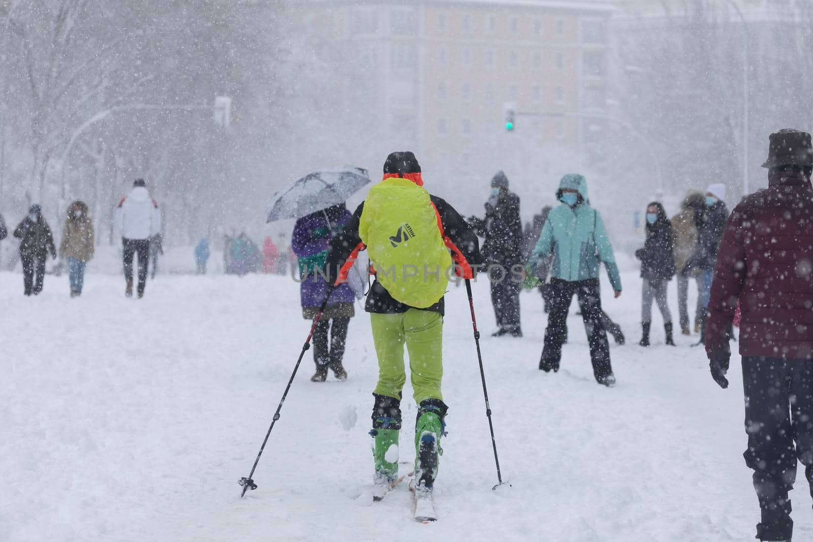 Madrid, Spain - January 09, 2021: A man enjoys skiing and doing sports in Menedez Pelayo avenue, on a snowy day, due to the Filomena polar cold front.