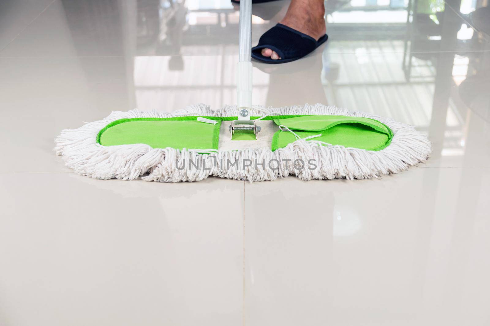 Clean the tile floor with a mop.