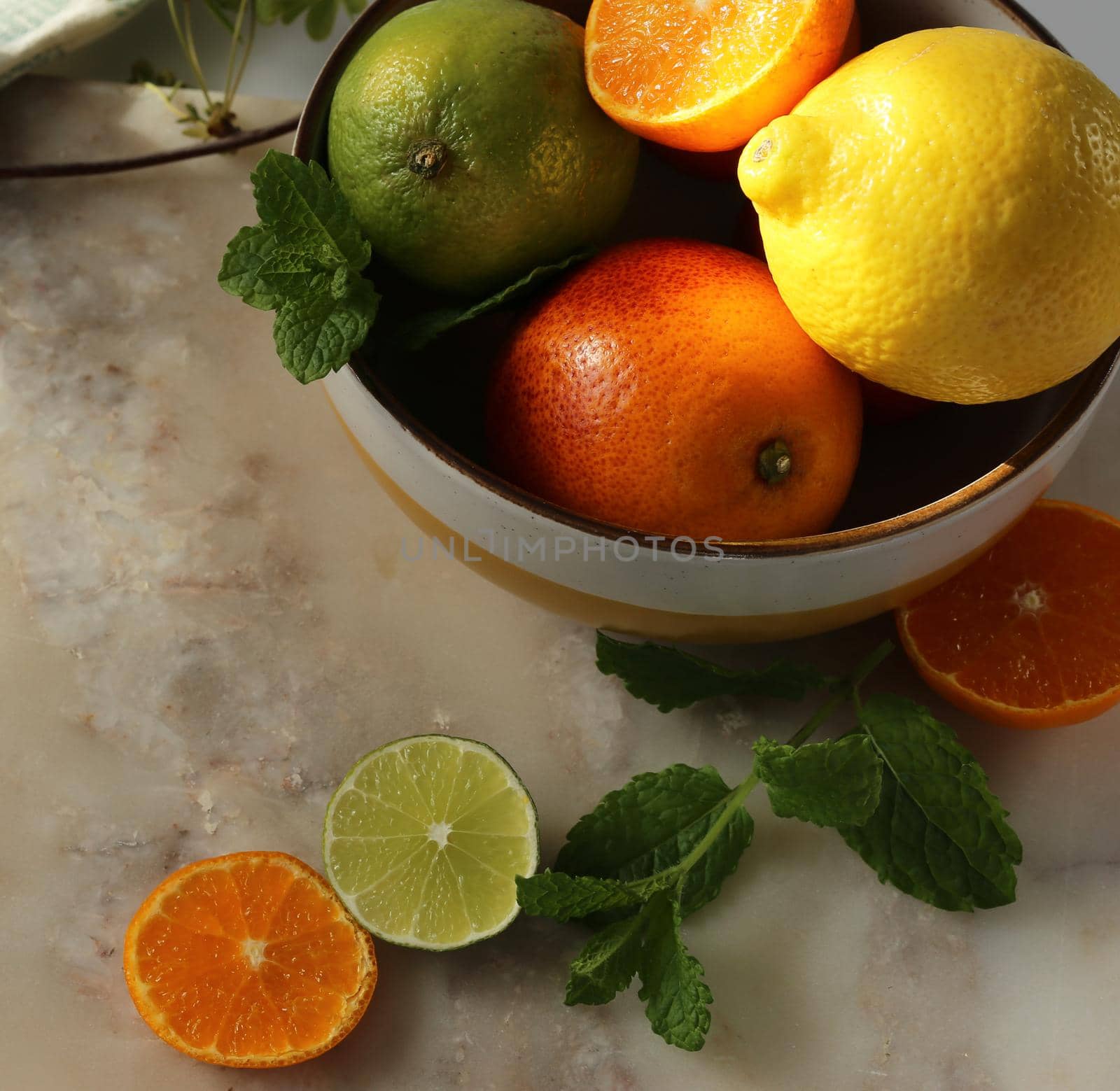 Home made food from citrus on marble background. Different citrus fruits mint in ball on kitchen table