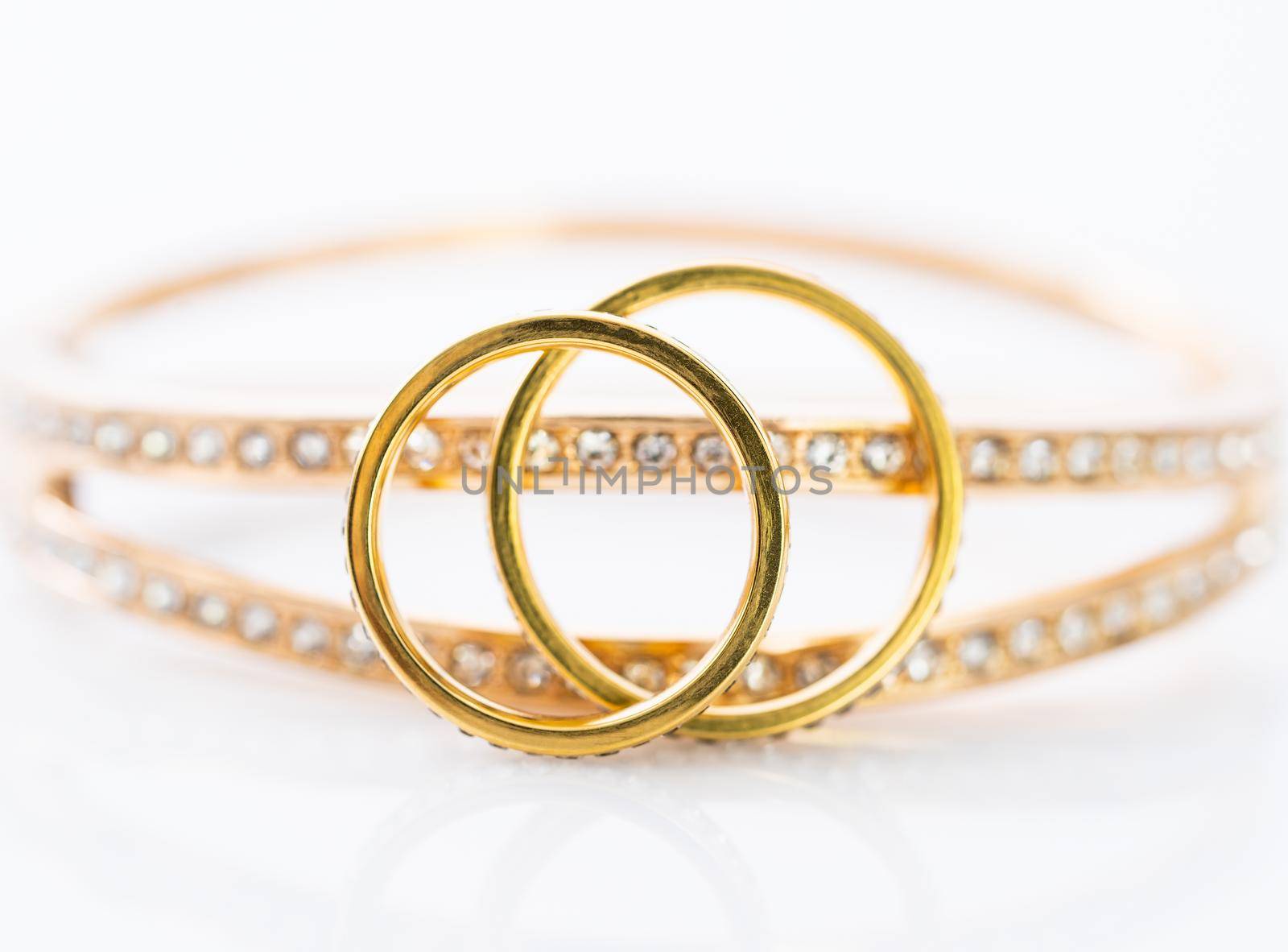 Gold wedding rings on white background by stoonn
