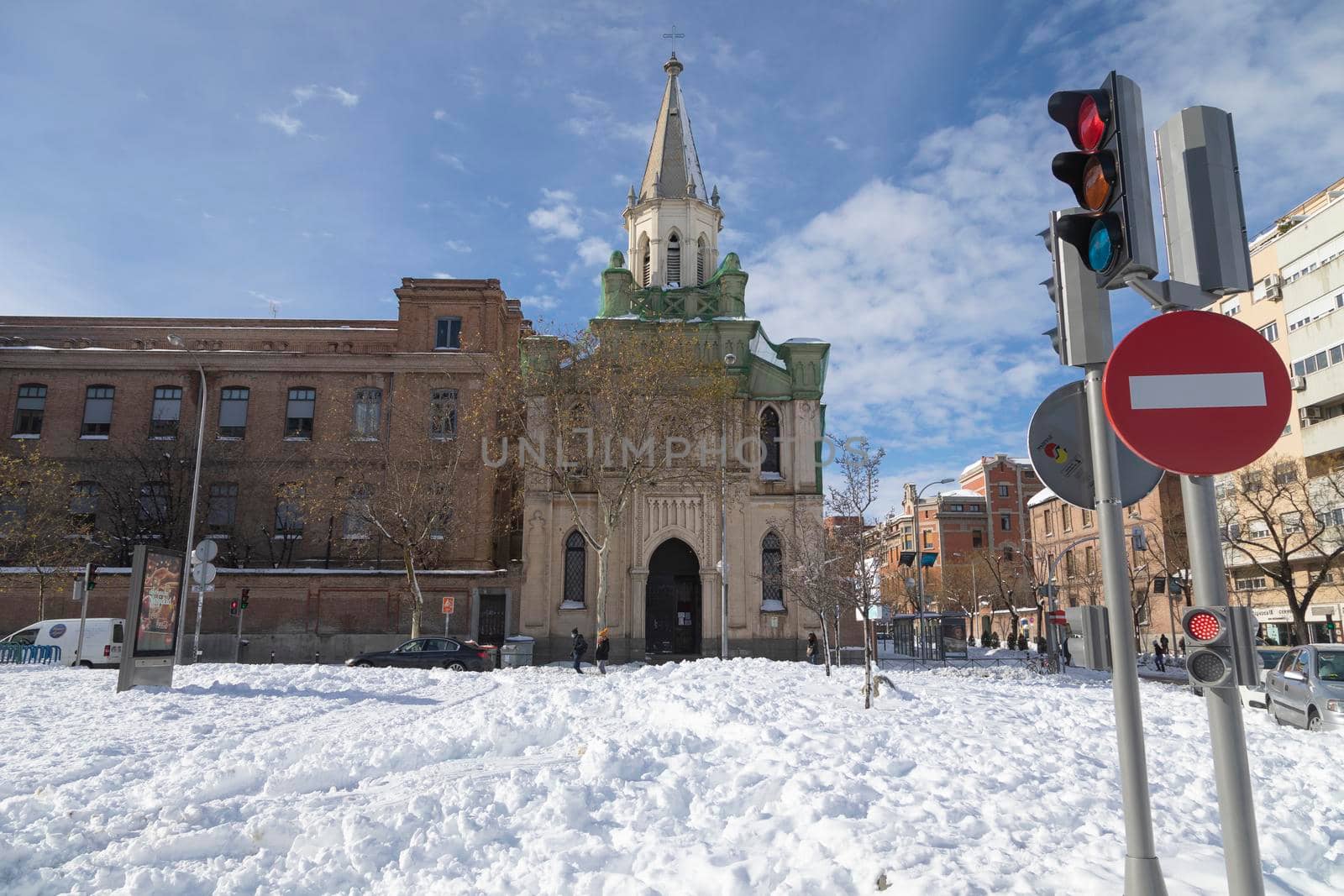 Madrid, Spain - January 10, 2021: Church of Our Lady of La Paz, seen from O'Donell street, on a snowy day, due to the Filomena polar cold front.