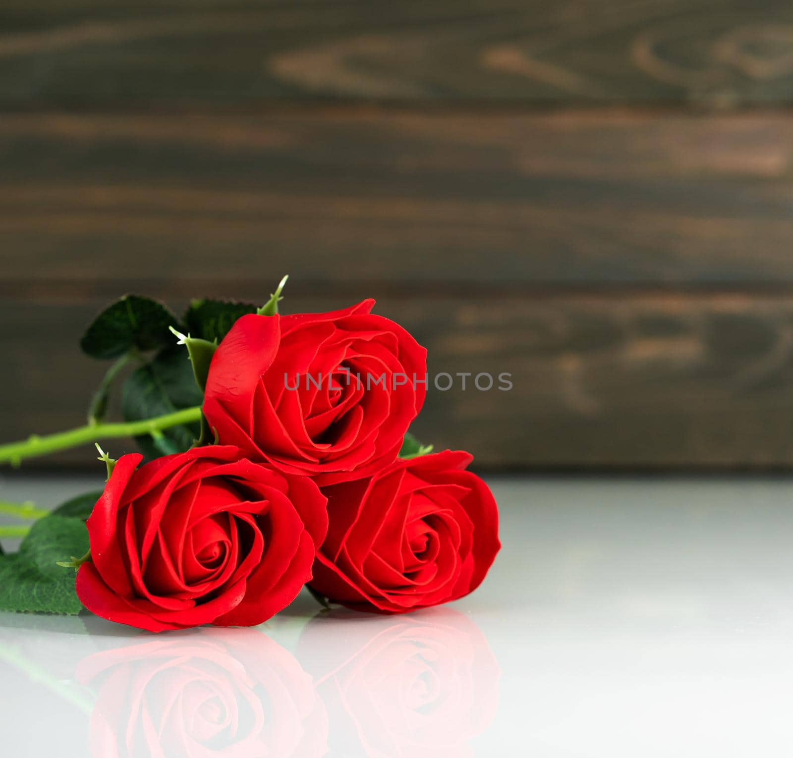 Red roses on table with copy space, Valentine's day background with red roses