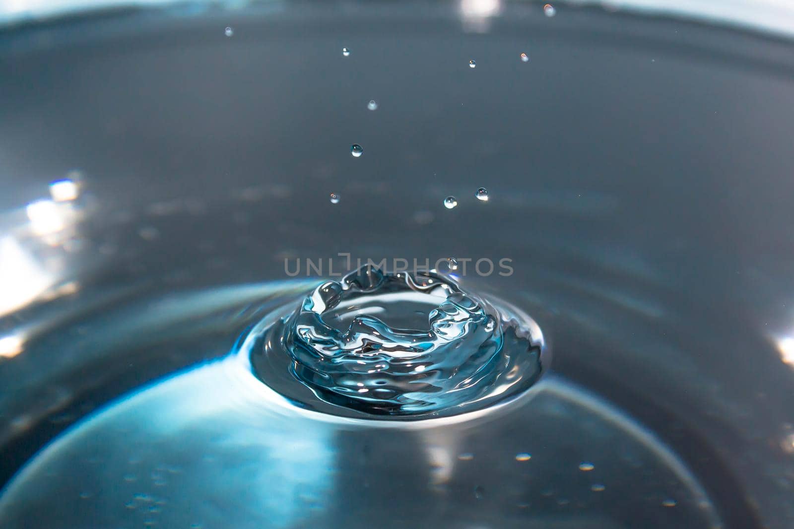 Water splash backgrounds close-up.Crown of blue water.Water drop.Frozen splashing in motion.