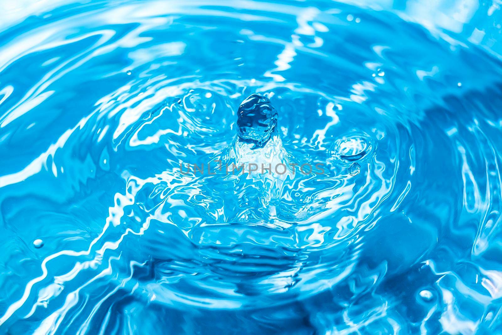 Abstract an outbreak of water. Splash of water close-up. Frozen water drop photographed at high speed.Slow dripping of liquid with air bubbles. Nature backgrounds or Wallpaper.Frozen liquid splashes by YevgeniySam