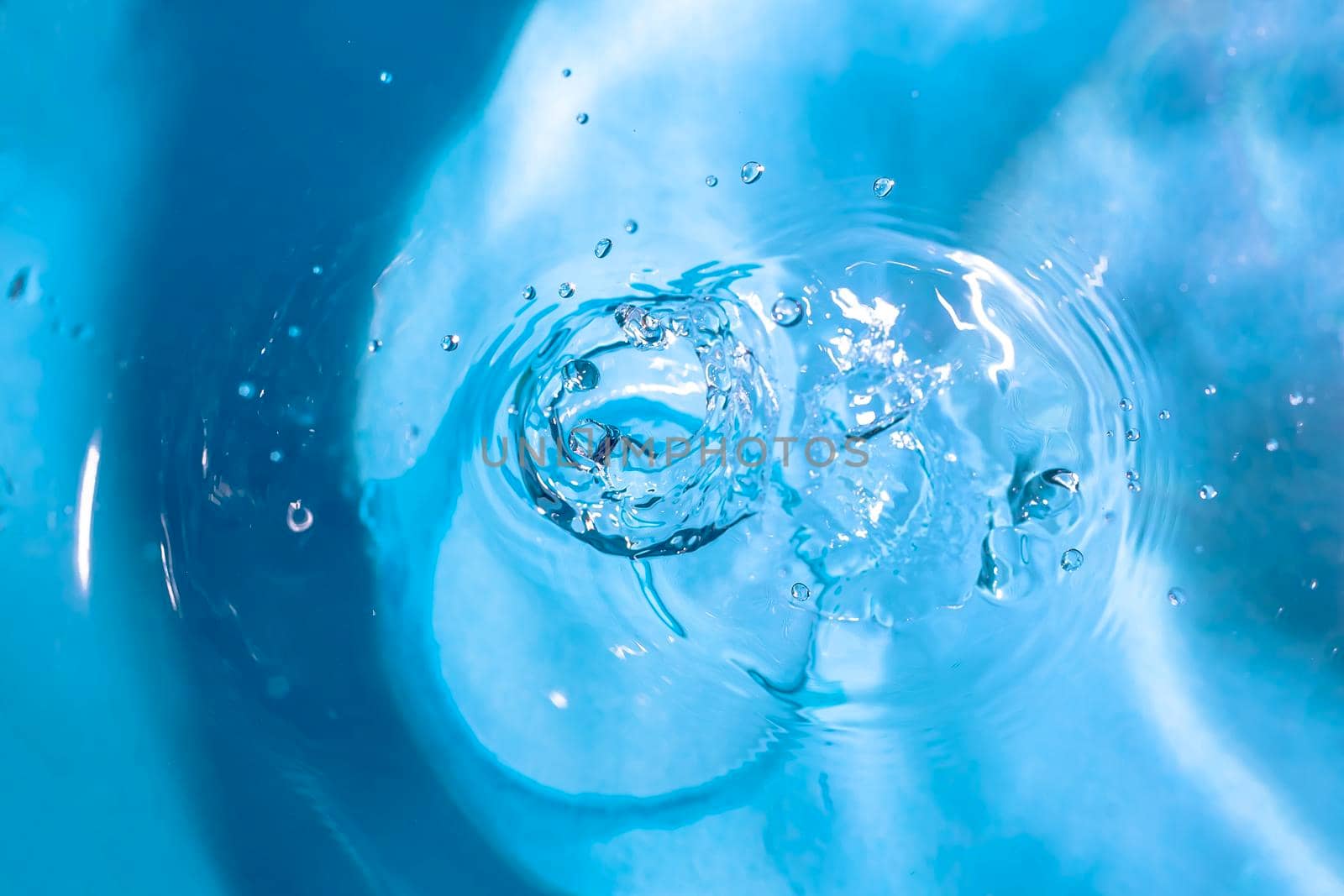 Water splash backgrounds close-up.Crown of blue water.Water drop.Frozen splashing in motion.Slow dripping of liquid with air bubbles. Nature backgrounds or Wallpaper.Frozen liquid splashes by YevgeniySam