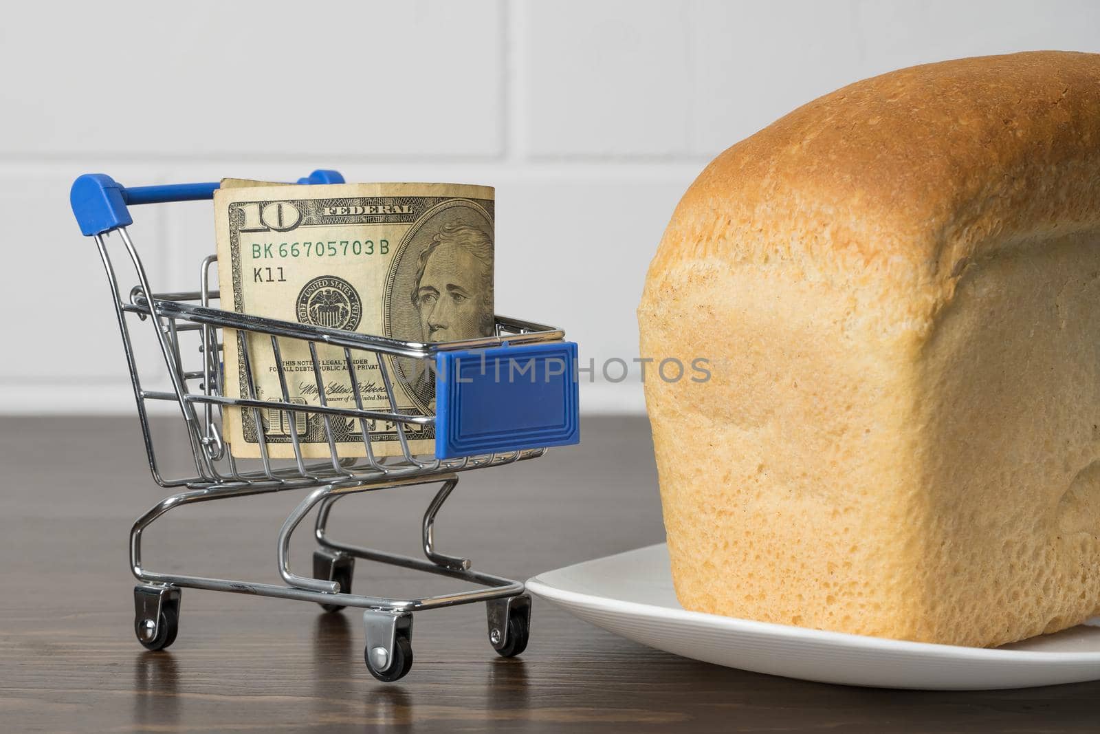 10 Dollars in a grocery basket with bread. Rising food prices and groceries in USA America and other countries. Humanitarian assistance