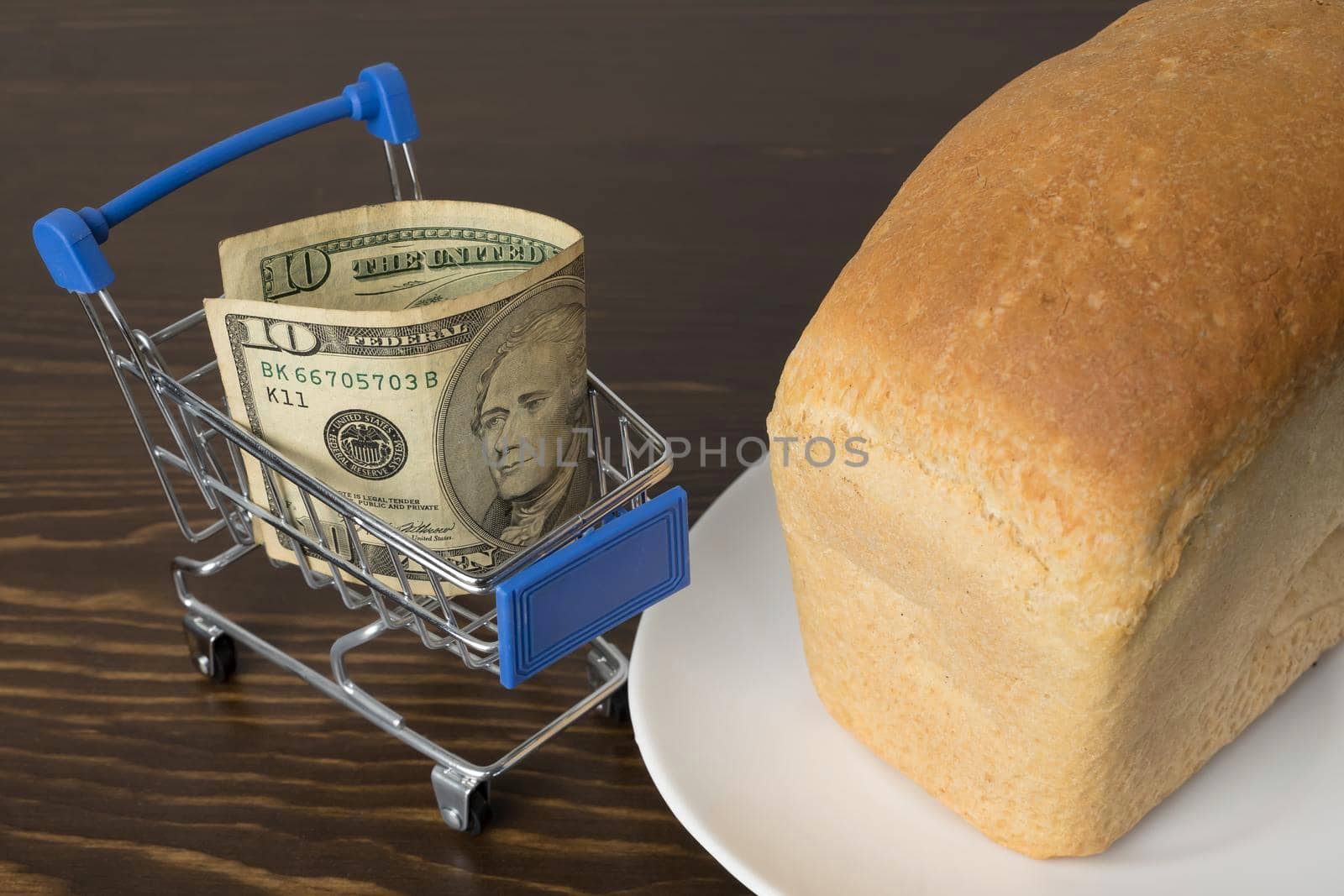 10 Dollars in a grocery basket with bread. Rising food prices and groceries in USA America and other countries. Humanitarian assistance