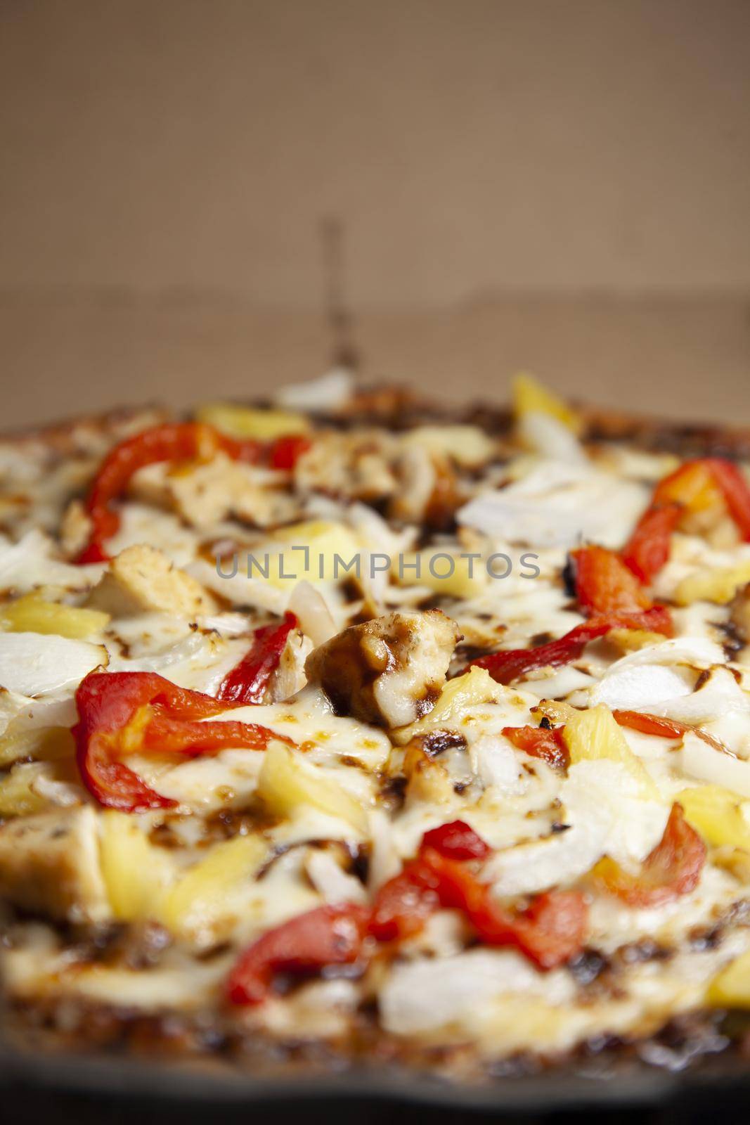 Barbeque chicken, red bell pepper, onion, pineapple pizza in its carryout box