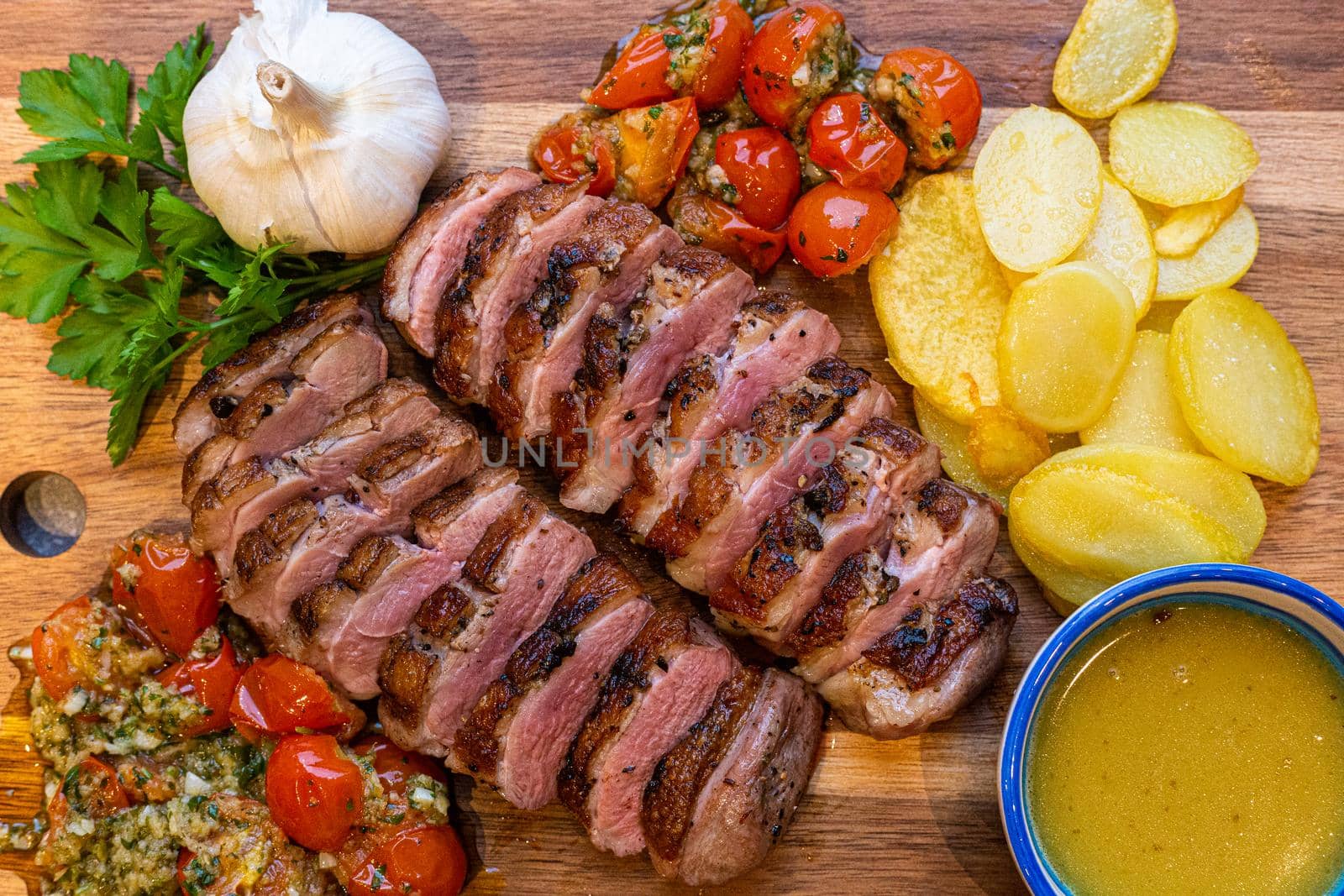 Grilled duck breast with juniper berries and a tomato persillade from the barbecue