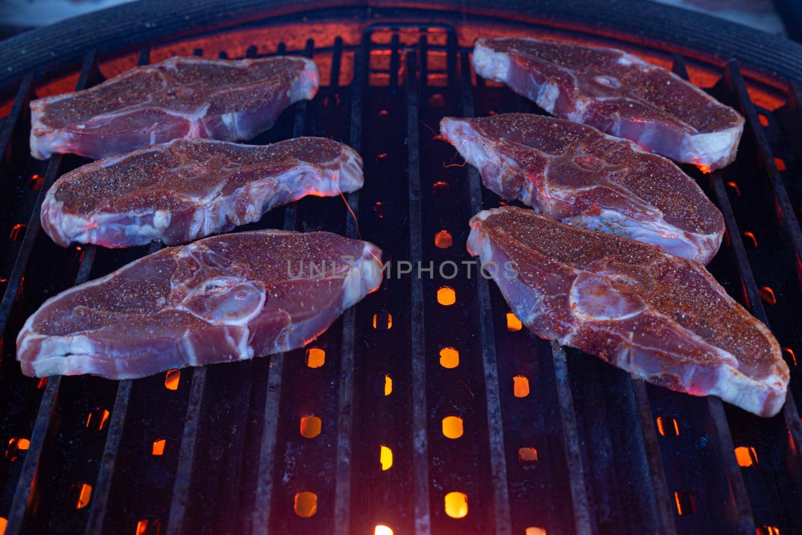 Lamb Chops grilling on barbecue with fire beneath by mlechanteur