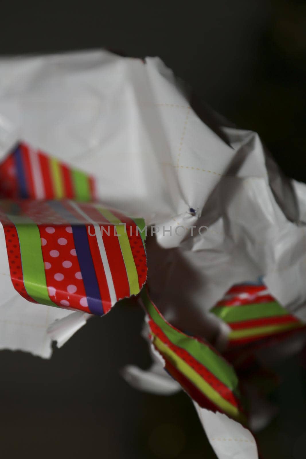 A woman ripping open a brightly colored gift