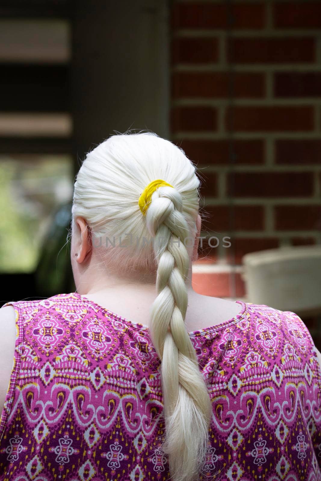 Woman wearing braids in her long, white hair
