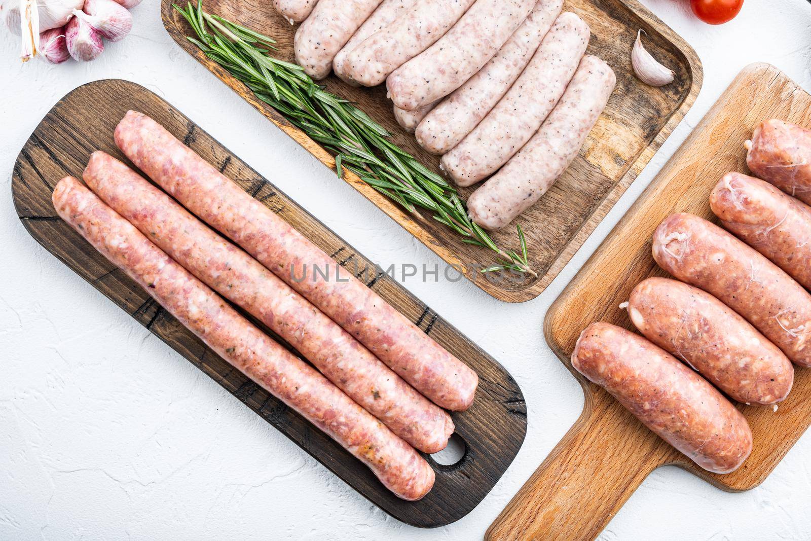 Raw homemade sausages, flat lay, on white background.