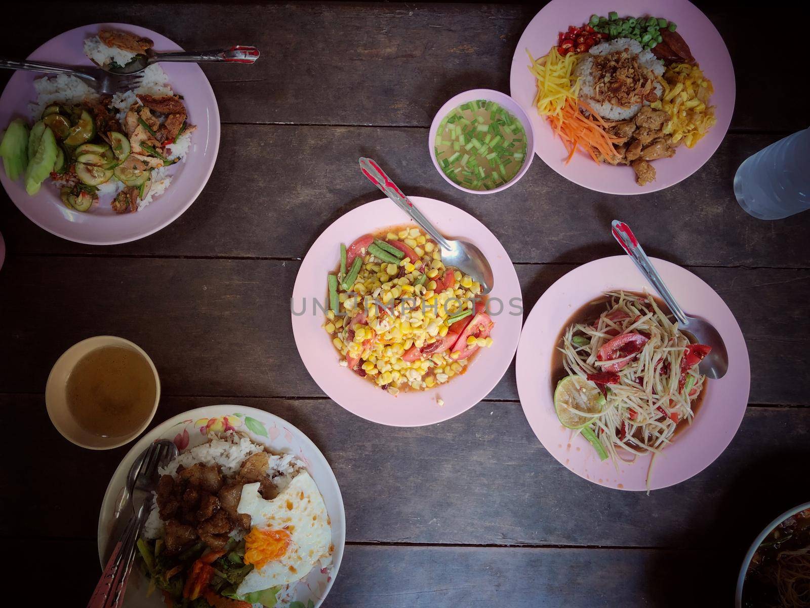 Top view Thai food on table: Eating north eastern foods (SOM TUM - Spicy Papaya Salad, Sticky rice). Local and traditional way. Thai Food Background. enjoy eating concept by NarinNonthamand