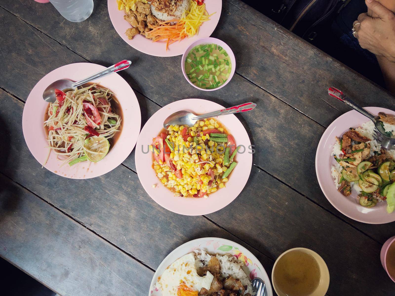 Top view Thai food on table: Eating north eastern foods (SOM TUM - Spicy Papaya Salad, Sticky rice). Local and traditional way. Thai Food Background. enjoy eating concept by NarinNonthamand